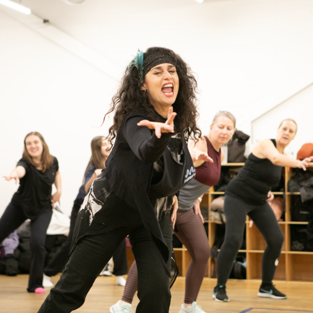 Adults dancing together in a street dance class at Marina Studios